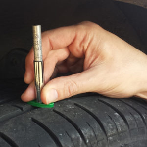 A tread depth gauge in use.